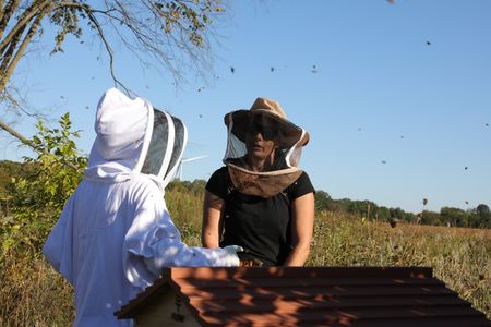 Beth Pol and bee expert, Meghan Milbrath, discuss the Pol family farm's hive's current status and ways to help them before winter begins. (National Geographic)