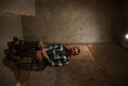 Arthur Williams is pictured in one of the tunnels underneath Almeria called the "Refugios" next to caving done by soldiers  in Spain. (National Geographic/Ciaran Henry)