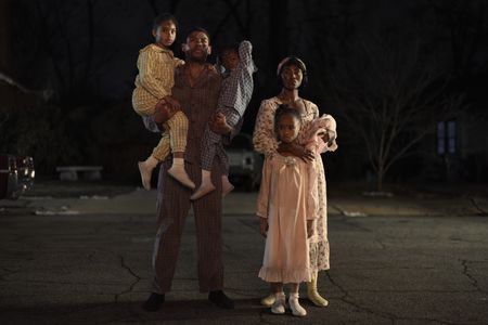 Malcolm X, played by Aaron Pierre, and Betty, played by Jayme Lawson, watch with their children as their house goes up in flames in GENIUS: MLK/X. (National Geographic/Zac Popik)