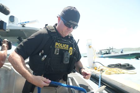 CBP AMO Agent Hud unties the boat from the dock in Fajardo, P.R. (Lucky 8 TV/Ivan Leon)