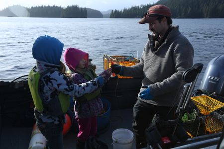 Cole Sturgis shows his kids Willow and Timber how to collect shrimp. (BBC Studios Reality Productions, LLC/Lukas Taylor)