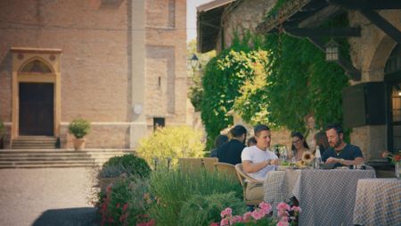 Antoni Porowski and Justin Theroux eating guinea fowl at Locanda del Falco. (National Geographic)