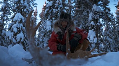 Ricko DeWilde finds a moose wrack with large antlers buried in the snow. (BBC Studios/Ryan Walsh)