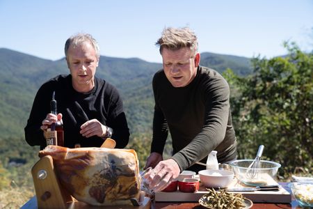 NC - Chef, William Dissen (L), and Gordon Ramsay take a break during the final cook in the Smoky Mountains of North Carolina to try a "country ham and bourbon luge". (Credit: National Geographic/Justin Mandel)