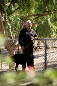 Cesar stands with Beast on a leash. (National Geographic)