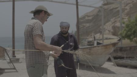 Maritime archaeologist Alessandro Ghidoni and craftsman Ayaz Al-Zadjali work on location in Qantab, Oman. (Windfall Films)