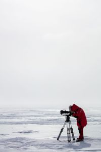 Camera operator Jeffery Garriock filming on a frozen lake in Wapusk National Park, Canada. (National Geographic for Disney/Henry Anderson-Elliott)