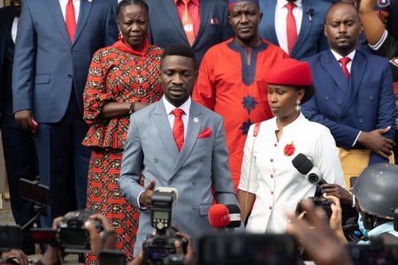KAMPALA, UGANDA - NOVEMBER 03: Bobi Wine and his wife, Barbie Itungo Kyagulany, address the media before leaving their house for the Presidential Nominations on November 03, 2020 in Kampala, Uganda. Popular singer Robert Kyagulanyi Ssentamu, better known by his stage name of H.E. Bobi Wine, is set to appear before the Independent Electoral Commission this morning to be nominated to stand against incumbent Yoweri Museveni in the upcoming Presidential elections in Uganda. He will be join candidate two former military Generals, Mugisha Muntu and Henry Tumukunde to contest the top seat in the election which will take place Thursday 18 February 2021. (Photo by Luke Dray/Getty Images)