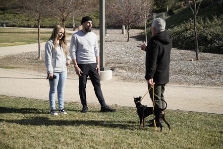 Ariana and Brandon talk to Cesar, who is holding Alpha on leash. (National Geographic)