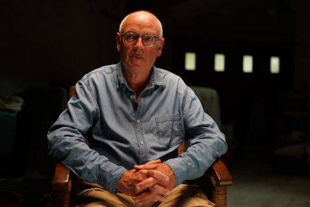 Stéphane Bourgoin is a French author and renowned specialist on serial killers, who since 2019 has been at the center of an internet-led controversy spearheaded by a group of anonymous true crime fans.  Here, Bourgoin poses for a portrait during the production of "Killer Lies: Chasing a True Crime Con Man," a documentary series about obsession and deception, following the unraveling of Stephane Bourgoin’s career as a best-selling author and serial killer expert. (National Geographic/Ben Selkow)