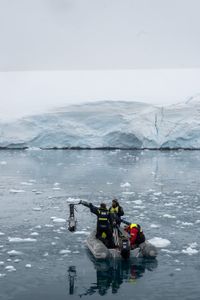 Producer Director Anthony Pyper, Camera Operator Justin Hoffman, and Skipper Skip Novak film orca in the Antarctic Peninsula. (National Geographic for Disney/Kenneth Perdigón)