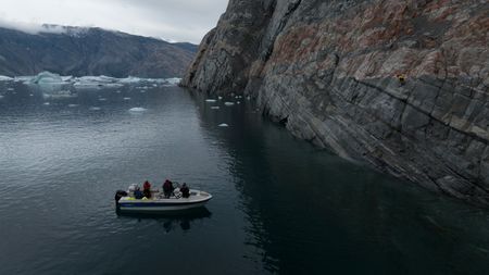 Boat below Ingmikortilaq. (photo credit: National Geographic/Matt Pycroft)