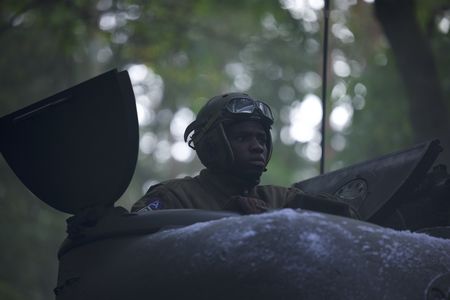 761st Black Panther Tank Battalion’s Tank Commander Johnnie Stevens (played by Juwon Adedokun) is pictured in a tank in a historic reenactment of the Battle of the Bulge produced for "Erased: WW2's Heroes of Color." Staff Sergeant Johnnie Stevens was a tank commander with the 761st Black Panther Tank Battalion who served in WW2.  (National Geographic/Rekha Garton)