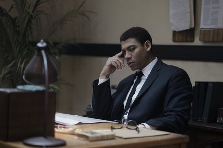 Malcolm X, played by Aaron Pierre, in his office in GENIUS: MLK/X. (National Geographic/Richard DuCree)