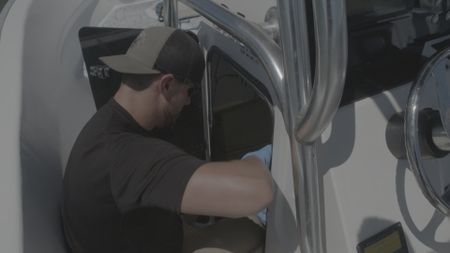 A CBP AMO Agent inspects the center console of a vessel suspected to be carrying drugs in Mayag¸ez, P.R.. (Lucky 8 TV/Paul Taggart)