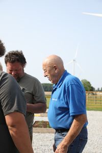 Andrew Hutton and Charles Pol speak with Dr. Pol at the Pol family farm's new garden. (National Geographic)