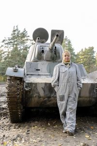 Alex Churchill with a T-26 tank. The Soviet army used thousands of t-26 tanks against Finland between 1939-'44. (National Geographic/Ciaran Henry)