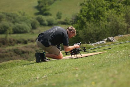 Drone operator Adam Clarke adjusts settings on the FPV drone. (National Geographic for Disney/Imogen Prince)