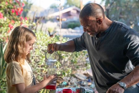 Annabelle teaches Christian Cooper how to make sugar water for the Costa Hummingbird feeders in her front yard in Palm Springs, CA. (National Geographic/Jon Kroll)