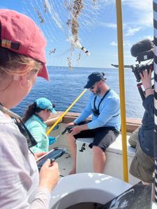 Turtle Scientists Katrina Phillips and Ryan Welsh are filmed on a boat off the coast of Florida. (National Geographic for Disney/Ruth Davies)
