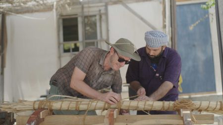 Maritime archaeologist Alessandro Ghidoni and craftsman Ayaz Al-Zadjali work on location in Qantab, Oman. (Windfall Films)