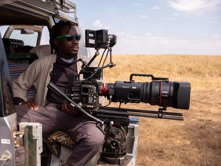 Camera Operator Manu Akatsa behind-the-scenes of Incredible Animal Journeys in Maasai Mara, Kenya. (National Geographic for Disney/David Chancellor)