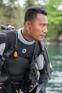 Award-winning photographer and experienced local dive guide, Benhur Sarinda, is geared up and ready to dive Lembeh Strait. (National Geographic for Disney/Craig Parry)