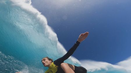 Justine Dupont looks up as she surfs a wave that is curling above her.  (Mandatory photo credit: Justine Dupont)