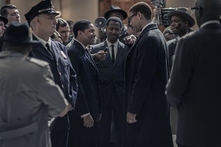 Martin Luther King Jr., played by Kelvin Harrison Jr., and Malcolm X, played by Aaron Pierre, are surrounded by reporters in the US Senate as seen in GENIUS: MLK/X. (National Geographic/Richard DuCree)