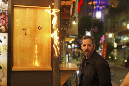 David Blaine prepares to spit fire onto a wooden sign.  (credit: National Geographic/Dana Hayes)