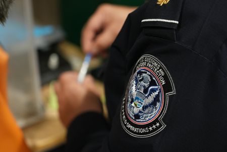 CBP Officer Bonilla is using a narcotics testing kit to identify the substance found smuggled in a suspect's vehicle in Calexico, Calif. (National Geographic)