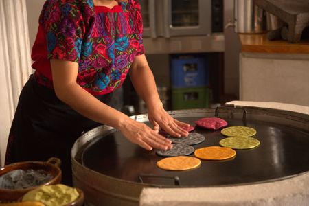 A member of the El Comalote Restaurant team cooks tortillas on the comal. The restaurant and tortillerÌa uses locally sourced and heritage ingredients in Antigua, Guatemala. (National Geographic/Adnelly Marichal)
