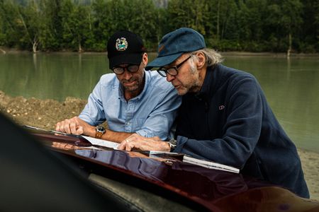 Joseph Fiennes and Sir Ranulph Fiennes consult a map on their way to Jasper, British Columbia, Canada. The Fraser River is behind them.  Amidst mountains and whale watching, Sir Ranulph Fiennes and his cousin Joseph Fiennes reflect on Ran’s epic life and his new challenge of life with Parkinson’s. (National Geographic)