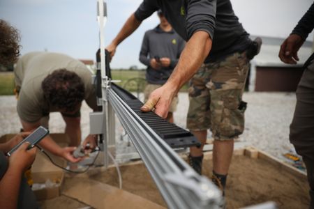 Charles Pol and Ben's employees install the Robot Garden system in the Pol family farm's garden. (National Geographic)