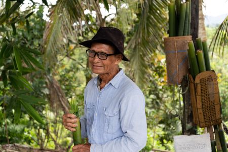 Abang Anak Engkamat holding his rice filled bamboo at Pematoh Longhouse. (National Geographic/Rebecca Eishow)