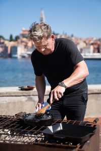 Croatia - Gordon Ramsay adds cuttlefish ink to his risotto at the final cook in Croatia. (Credit: National Geographic/Justin Mandel)