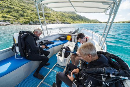 Left to right: Cinematographer, Rory McGuinness, dive supervisor, Flemming Høyer, and Series Director and DoP, Adam Geiger, completing CCR safety checks to dive and film Day octopus (Octopus cyanea) on the Great Barrier Reef.   (photo credit: National Geographic/Harriet Spark)