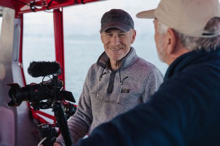 Director and cinematographer, Adam Geiger, filming on a dive boat in Port Philip Bay with producer and cinematographer Rory McGuinness.   (National Geographic for Disney/Harriet Spark)