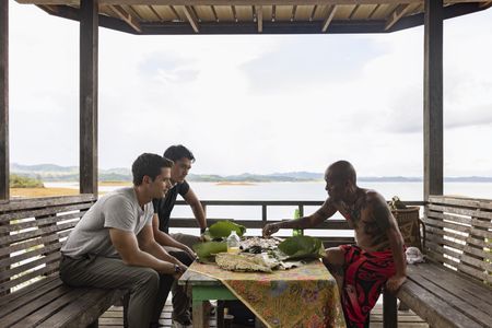 Antoni Porowski, Henry Golding and Peter enjoy a meal together in Batang Ai. (Credit: National Geographic/Annice Lyn)