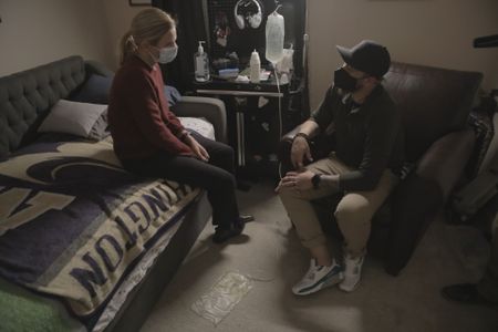 Mariana van Zeller (L) interviews kidney patient Garrett Rowe as he connects to his dialysis machine. (Credit: National Geographic)