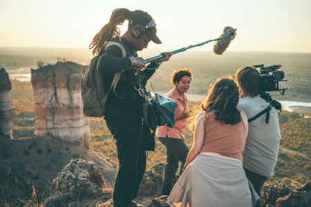 Behind the scenes of the film crew recording Paula Kahumbu as she witnesses the elephants at Gonarezhou National Park, Zimbabwe, scaling down the Chilojo Cliffs. (National Geographic for Disney/Freddie Claire)