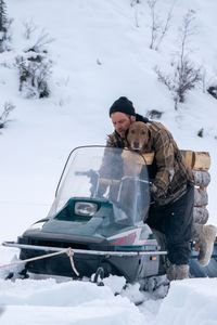 Johnny Rolfe and his dog Java riding on his snowmobile. (BBC Studios Reality Production/Patrick Henderson)