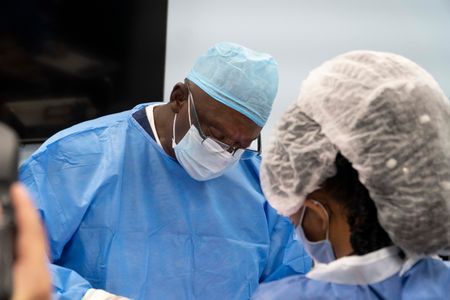 Dr. Ferguson concentrates while performing a difficult surgery. (National Geographic for Disney/Sean Grevencamp)