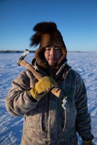 Gage Hoffman setting fish nets under the ice with his brother for subsistence food during the winter season. (BBC Studios Reality Productions, LLC/Isaiah Branch - Boyle)