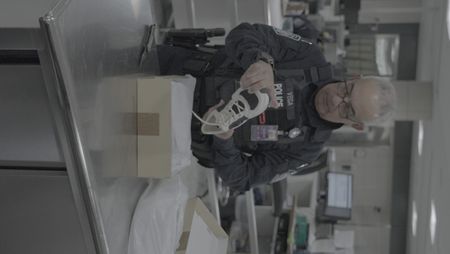 CBP Officer Vega inspects a shoe found in a box in a courier's belongings in Dulles, Va. (National Geographic)