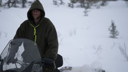 Jessie Holmes breaks trail with his snowmobile while traveling near his cabin. (BBC Studios Reality Productions, LLC/JR Masters)