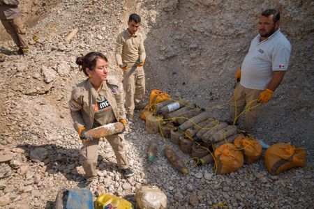 Sinjar, Iraq - Hana Khidera (L) prepares mines for destruction. (Sean Sutton)