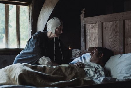 Agnes Sampson chanting prayers as she tends to an ill man's bedside. (Dash Productions Services LTD/Antoan Ivanov)