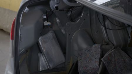 A CBP officer uses a narcotics test kit to test a suspicious substance found in a passenger's luggage. in El Paso, Texas. (National Geographic)