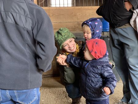Beth Pol smiles with Abigail and Silas Pol, after feeding their new sheep, Princess Leia, at the Onstott Family Farm before bringing her to the Pol family's farm. (National Geographic)